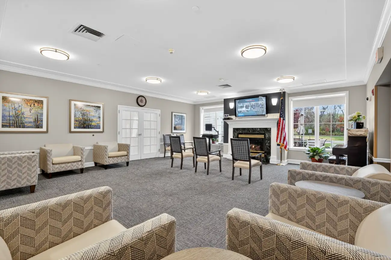 a communal area with chairs and a tv