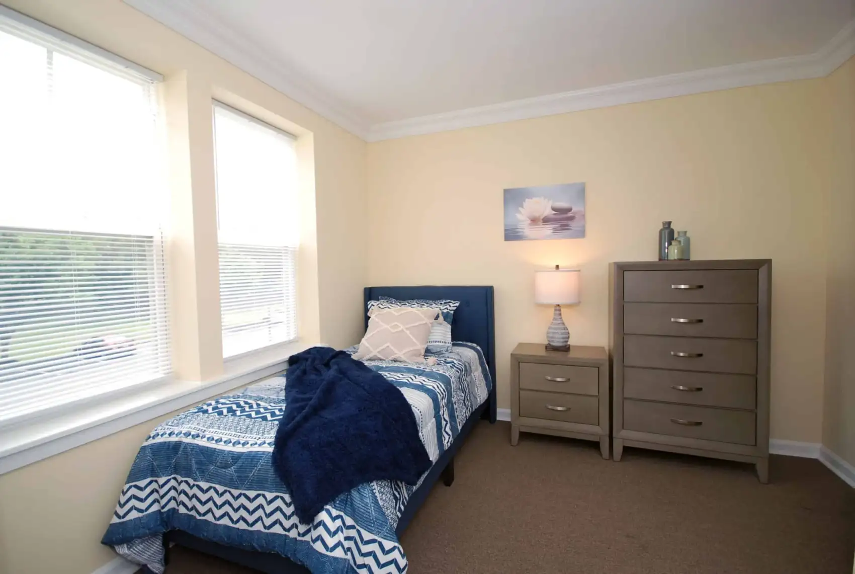 a bedroom with two windows