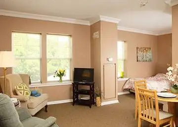 a living room with a tv and a dining area
